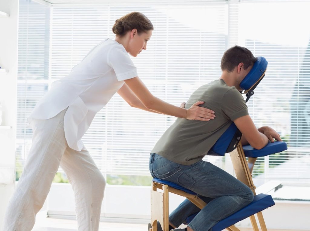 A woman giving a man massage therapy in Spokane valley